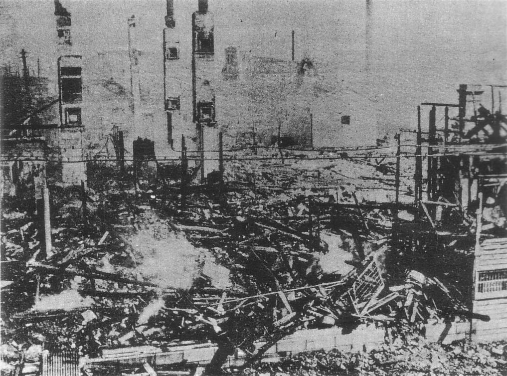 Shops lie in ruins after being burned down by rioters